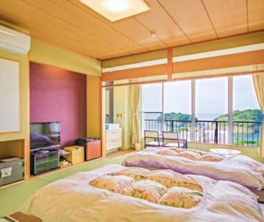 Three futon beds on tatami with balcony and green landscape at Futagojimasou, Wakayama