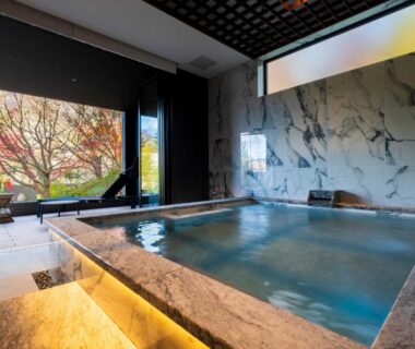 Indoor marble onsen bath with garden view at Gekkoju Yufuin, Ōita, Kyūshū