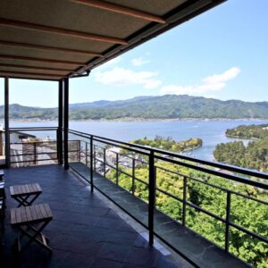 Balcony chairs overlooking sandbar and bay at Genmyoan, Kyoto