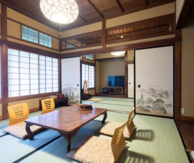 Traditional tatami room with low wooden table, zaisu chairs, shoji screens and decorative fusuma at Gensen Uenoya in Kanagawa