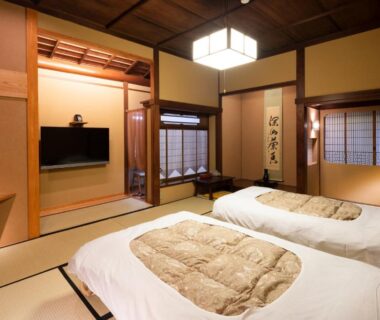 Traditional tatami room with twin futon bedding and shoji screens at Gensen Uenoya, Kanagawa