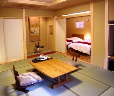 Tatami room with low wooden table and adjoining futon beds at Gero Onsen Yukyunohana in Gifu