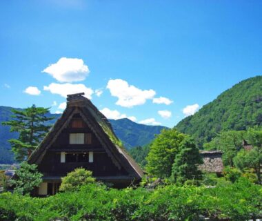 Thatched roof house amid green mountains at Gero Onsen Yukyunohana, Gifu, Chūbu