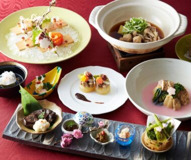 Assorted small-plate Japanese meal served on red cloth at Gingetsu ryokan, Nagano, Chūbu Japan