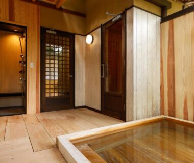 Indoor wooden soaking tub in a wood-lined room with shoji screens at Ginsuisou Choraku Hyōgo