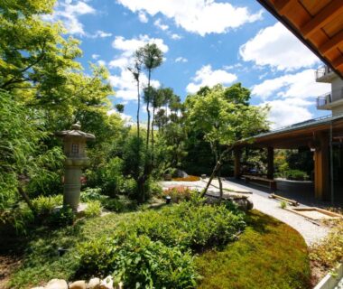 Stone lantern and moss garden beside wooden corridor at Ginsuisou Choraku Hyōgo, Kansai