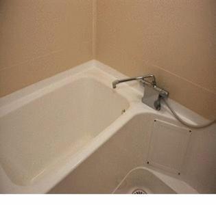 Compact bathtub with handheld shower in bathroom at Gion Fukuzumi Kyoto
