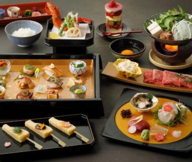Assorted traditional dishes on lacquer trays with hot pot and sashimi at Gion Ryokan Karaku, Kyoto