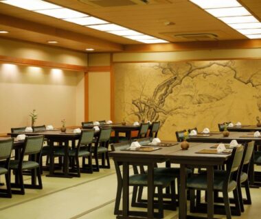 Traditional tatami dining hall with low tables and chairs at a Kyoto ryokan