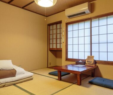 Tatami room with shoji screens, low table and futon at Gion Ryokan Q-beh in Kyoto, Kansai