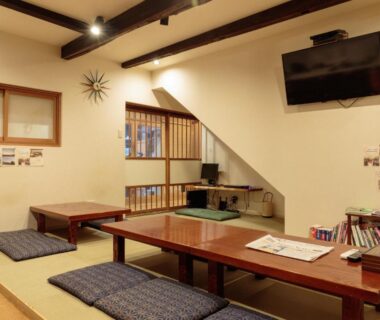 Tatami seating with low wooden tables and cushions at Gion Ryokan Q-beh in Kyoto