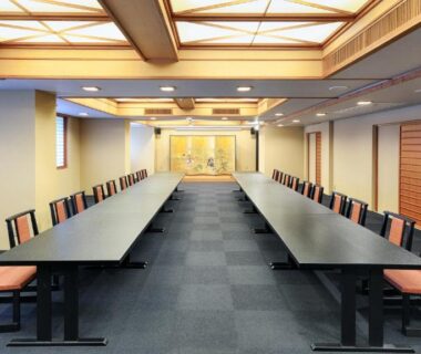 Long conference room with parallel tables and chairs at Gion Shinmonso in Kyoto