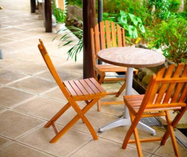 Wooden chairs and round table on tiled veranda at Good Stay Mizuho, Ōita, Kyūshū, Japan