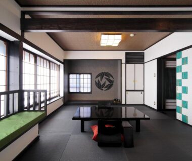 Traditional tatami room with low lacquer table, zabuton cushion, shoji screens and window bench at Goyokan Shizuoka