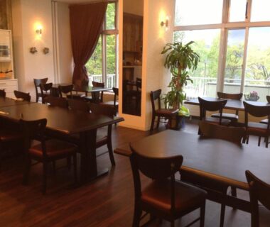 Dining area with wooden tables and large windows at Granvillage Toya Daiwa Ryokan Annex Hokkaidō Japan