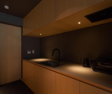 Dimly lit wooden kitchenette with sink, kettle and toaster oven at Gunjo no Tsuki, Chūbu, Ishikawa, Japan