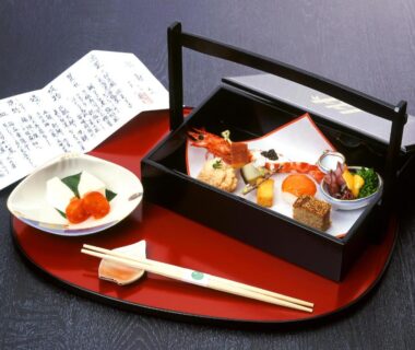 Lacquer tray with bento box of assorted small dishes, chopsticks and menu at Gyokutei in Kanagawa