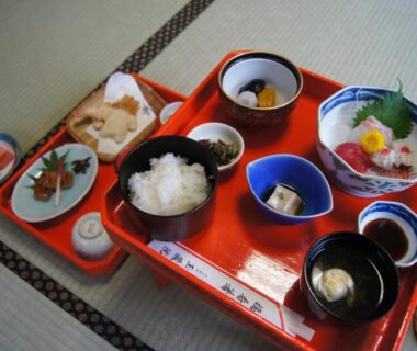 Lacquer tray with traditional Japanese breakfast bowls, rice and side dishes on tatami at Gyokuzoin, Nara