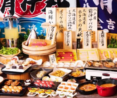 Assorted sushi and seafood plates with Japanese labels at HAKODATE Uminokaze Hokkaidō ryokan dining