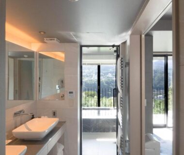 Bright ensuite with dual sinks, large mirror and balcony overlooking Kanagawa hills at HAKONE NICA