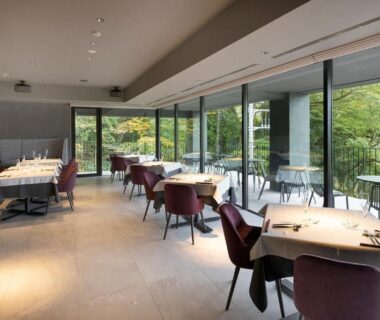 Modern dining area with floor-to-ceiling windows overlooking greenery at HAKONE NICA, Kanagawa, Kantō, Japan