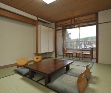 Traditional tatami guest room with low table, floor chairs and balcony view at HESTA Hakone in Kanagawa