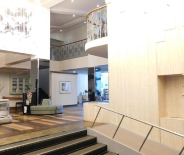 Bright modern lobby with sofas, staircase, mezzanine and chandeliers at HESTA Hakone, Kanagawa Japan