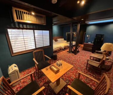 Low table and chairs, two beds and shoji window at HOTEL Clam Chowder in Kyoto, Kansai, Japan
