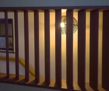 Wooden slats and hanging lantern at HOTEL HOUSE LEE interior corridor with warm ambient lighting