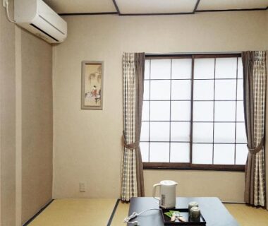 Tatami room with low table, shoji window and kettle at HOTEL HOUSE LEE Tokyo