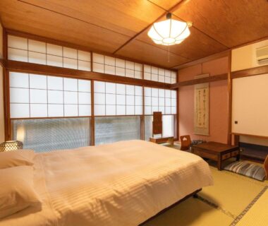 Tatami room with Western beds, shoji screens and low table at HOTEL SHIRAHAMAKAN in Wakayama, Kansai