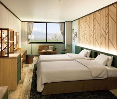 Twin beds with seating and window view at Hachimantai Mountain Hotel & Spa in Iwate, Tōhoku, Japan