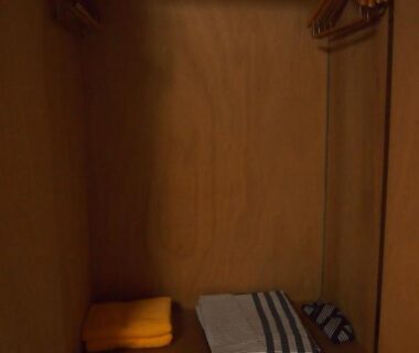 Wooden wardrobe with hangers and folded linens in a ryokan room at Hagurokan, Yamagata, Tōhoku, Japan
