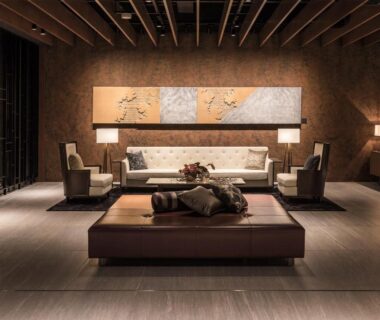 Warm-lit hotel lounge with sofa, low ottoman and wooden ceiling beams at Hakodate Kokusai Hotel Hokkaidō
