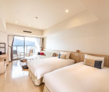 Bright twin beds with balcony seating at Hakone Ashinoko Hanaori in Kanagawa, Kantō, Japan