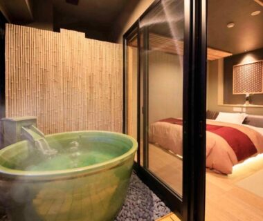 Room with ceramic balcony tub, tatami flooring and low beds at Hakone Fuga in Kanagawa