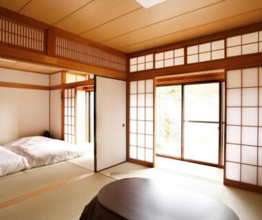 Bright tatami room with futon beds, shoji screens and low table at Hakone Fura in Kanagawa