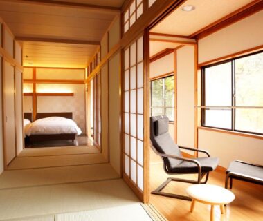 Tatami room with shoji screens, low seating and sunlit windows overlooking garden at Hakone Fura, Kanagawa