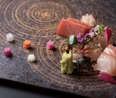 Assorted sashimi with wasabi and floral garnishes on a decorative plate at Hakone Gora KARAKU, Kanagawa