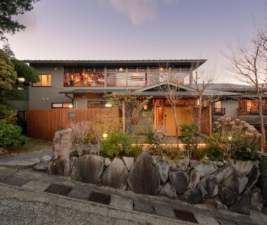 Wooden ryokan exterior with stone garden and entrance at Hakone Gora Ten in Kanagawa, Japan