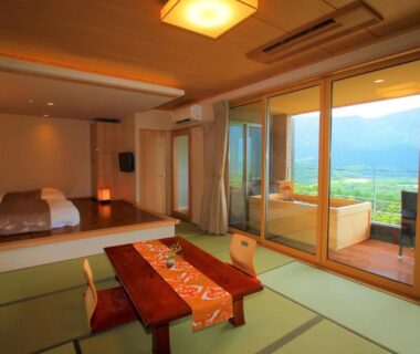 Tatami room with low table and outdoor wooden bath on terrace at Hakone Hoshi no Akari in Kanagawa, Japan
