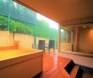 Wooden bath on covered terrace with seating and garden view at Hakone Hoshi no Akari Kanagawa