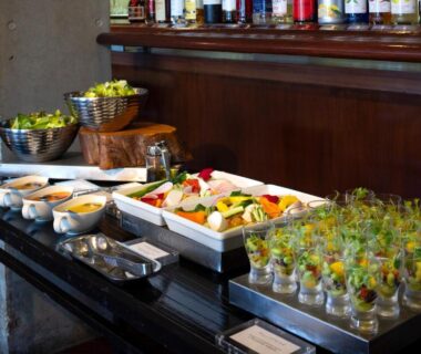 Buffet with glass appetizers, salad trays and condiments on a wooden counter at Hakone Hotel in Kanagawa