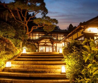 Stone steps and lanterns leading to Hakone Kowakien Mikawaya Ryokan entrance in Kanagawa at dusk
