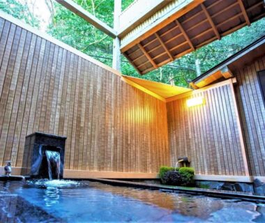 Outdoor wooden bath with water spout and tall wooden walls at Hakone Kowakien Mikawaya Ryokan, Kanagawa