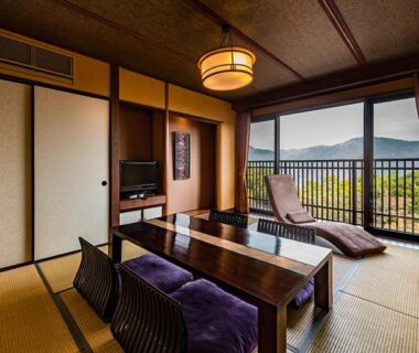 Tatami room with low table and balcony overlooking mountains at Hakone Kyuan, Kanagawa