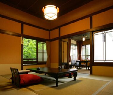 Traditional tatami room with low table, floor cushions and shoji screens at Hakone Onsen Ryokan Yaeikan, Kanagawa, Japan