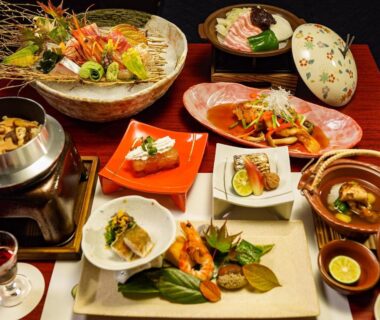 Assorted traditional Japanese dishes arranged on low table in ryokan dining setting at Hakone Onsen Yuyado Yamanoshou Kanagawa