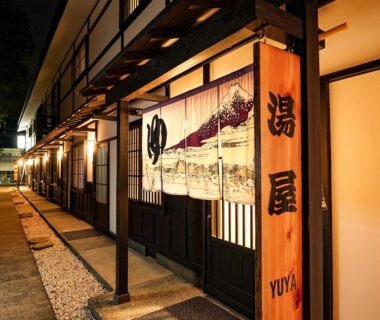Lantern-lit corridor with noren and wooden sign at Yuyado Yamanoshou, Hakone, Kanagawa