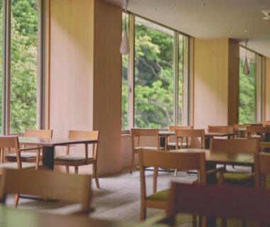Spacious wooden dining area with large windows overlooking forest at Hakone Pax Yoshino in Kanagawa